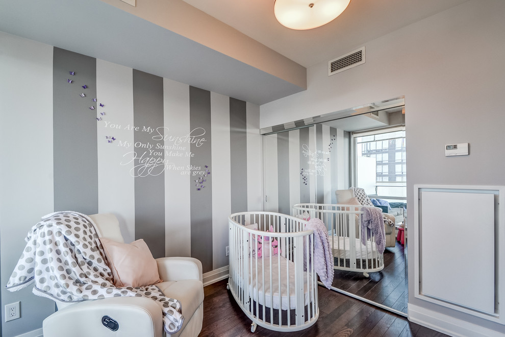 Example of a mid-sized transitional girl dark wood floor and brown floor nursery design in Toronto with multicolored walls