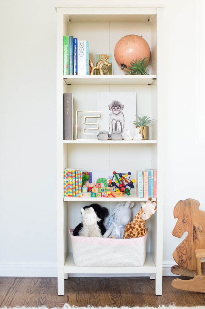 Inspiration for a mid-sized eclectic girl medium tone wood floor nursery remodel in San Diego
