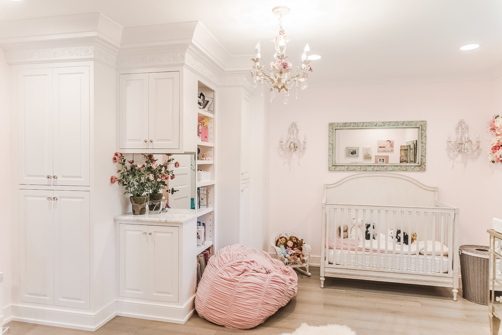 This is an example of a large classic nursery for girls in Indianapolis with medium hardwood flooring.