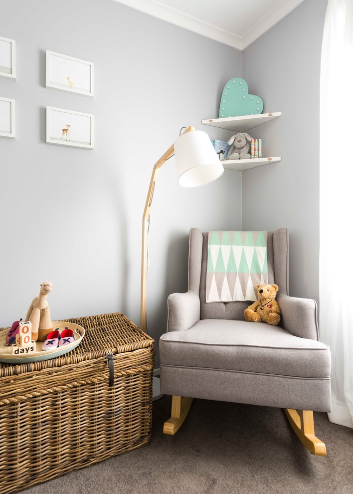 This is an example of a small scandinavian gender neutral nursery in Melbourne with grey walls, carpet and brown floors.