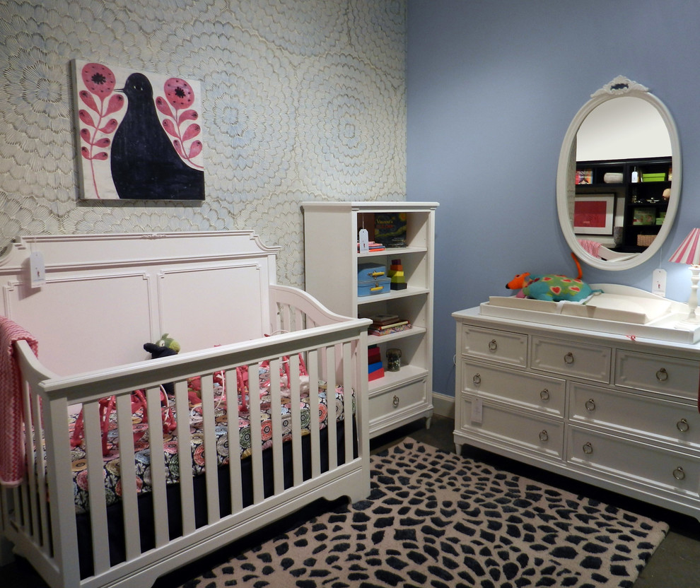 Medium sized bohemian nursery for girls in Other with blue walls.