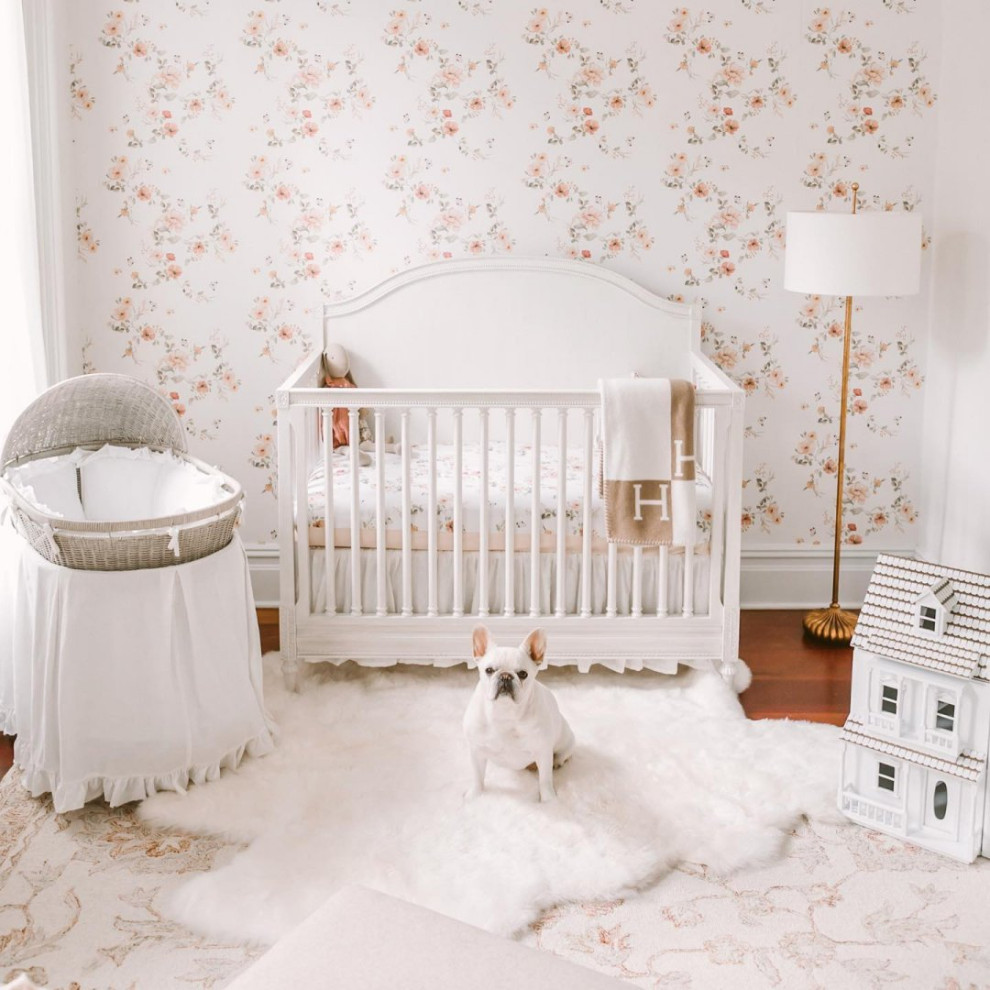This is an example of a large traditional nursery for girls in New York with white walls, dark hardwood flooring, brown floors and wallpapered walls.