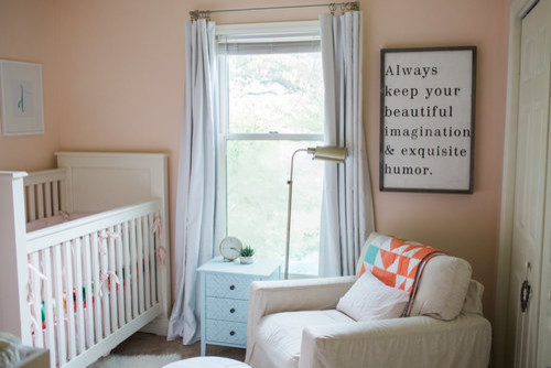 Small modern nursery for girls in Other with pink walls and carpet.