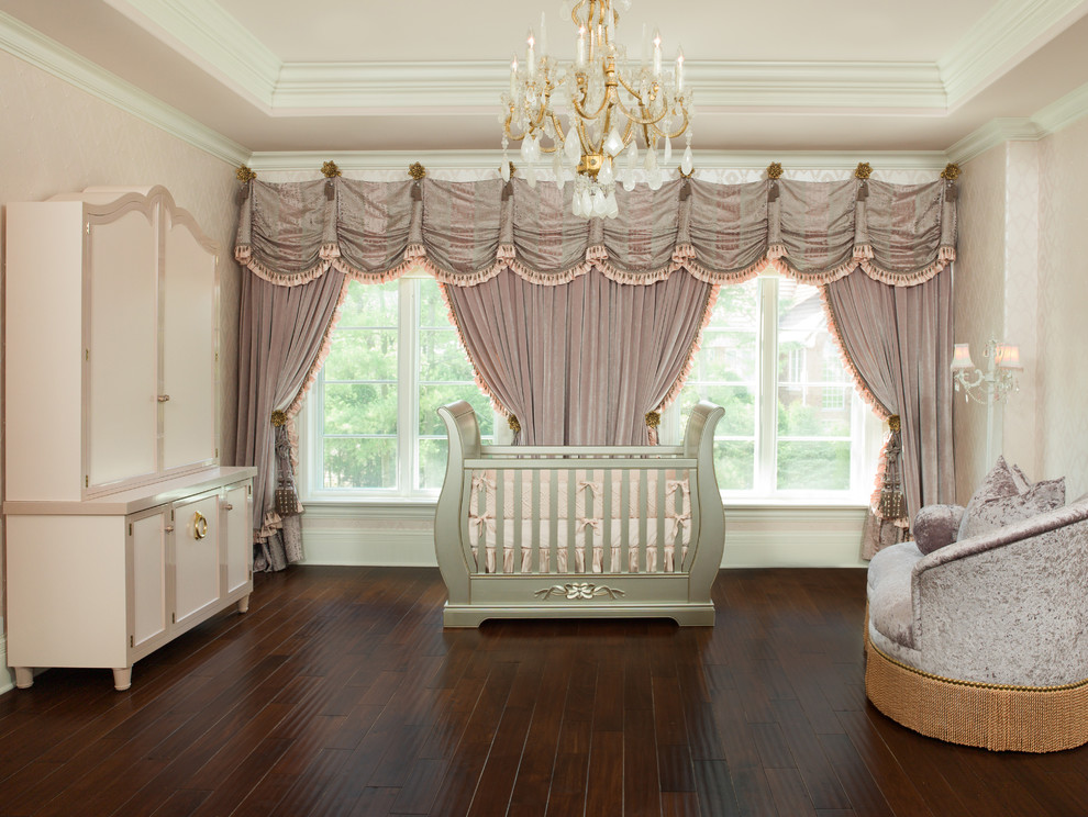 Large classic nursery for girls in Chicago with pink walls, dark hardwood flooring and brown floors.