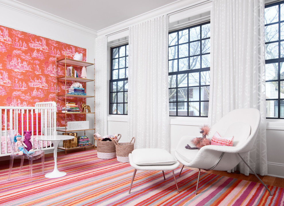Inspiration for a traditional nursery in Chicago with white walls, medium hardwood flooring and pink floors.