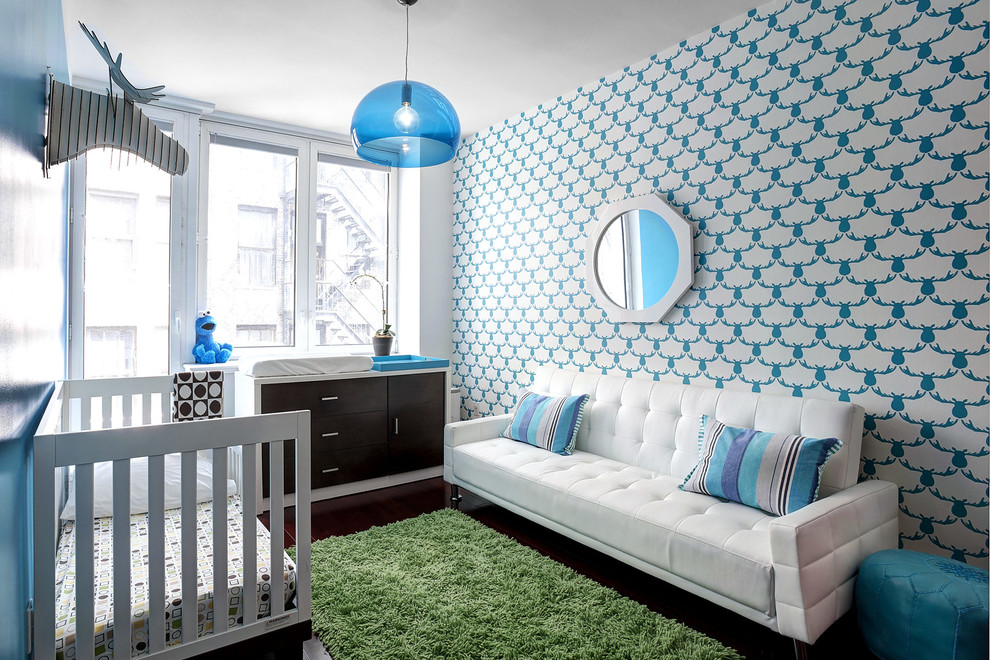 Photo of a medium sized contemporary nursery for boys in New York with blue walls, dark hardwood flooring and feature lighting.