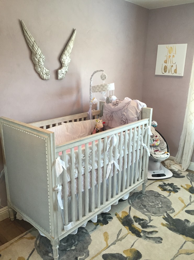 Inspiration for a medium sized traditional nursery for girls in Orange County with purple walls, dark hardwood flooring and brown floors.