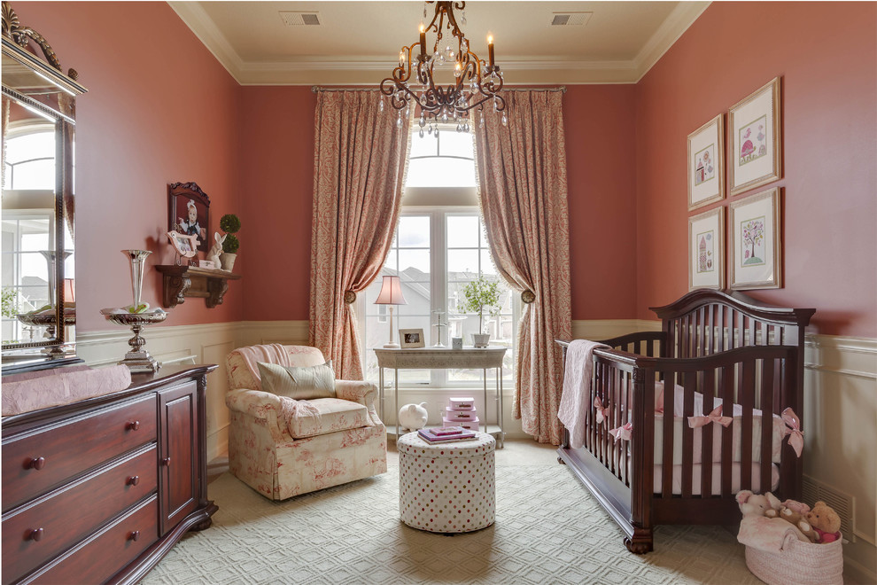 Inspiration for a medium sized traditional nursery for girls in Kansas City with pink walls.