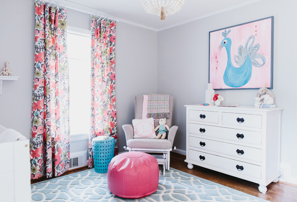 Design ideas for a medium sized classic nursery for girls in Atlanta with grey walls and medium hardwood flooring.