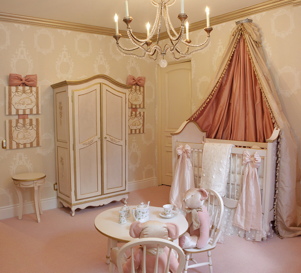 Traditional nursery for girls in Los Angeles with beige walls and carpet.