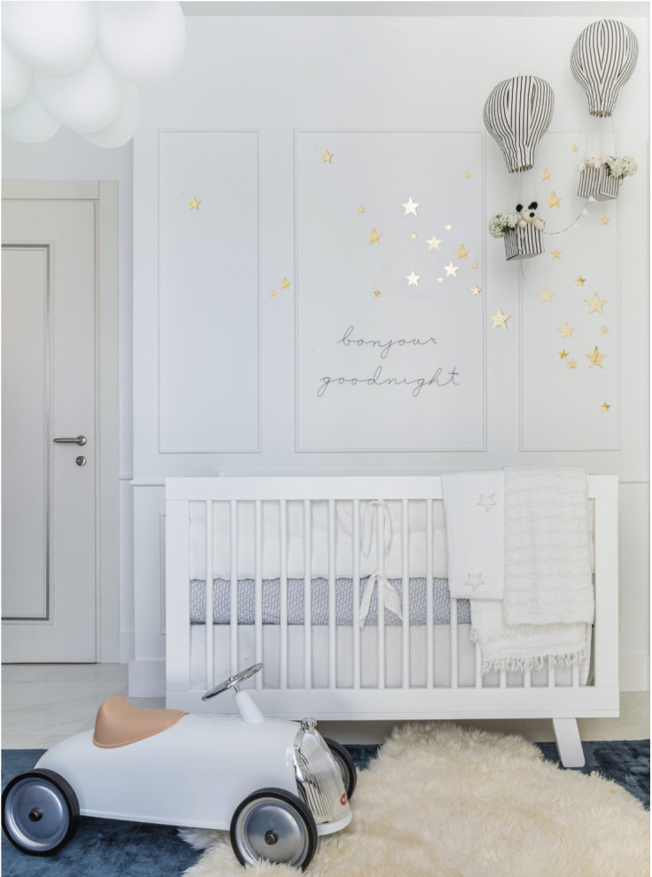 Exemple d'une chambre de bébé garçon moderne de taille moyenne avec un mur blanc, un sol en marbre et du lambris.
