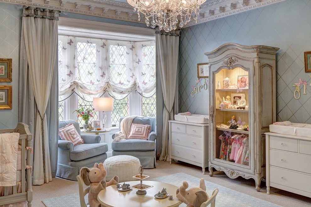 Diseño de habitación de bebé niña clásica grande con paredes azules, moqueta y suelo beige