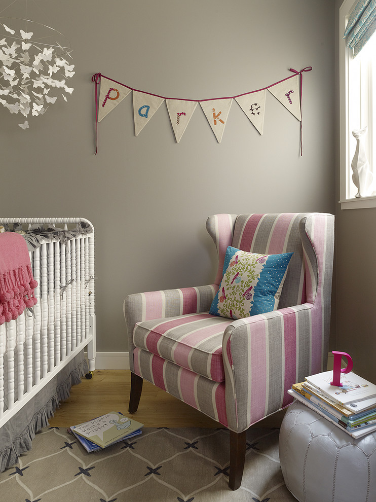 Nursery - small transitional girl light wood floor nursery idea in San Francisco with gray walls