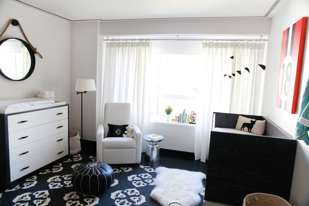 Mid-sized transitional boy dark wood floor nursery photo in New York with white walls