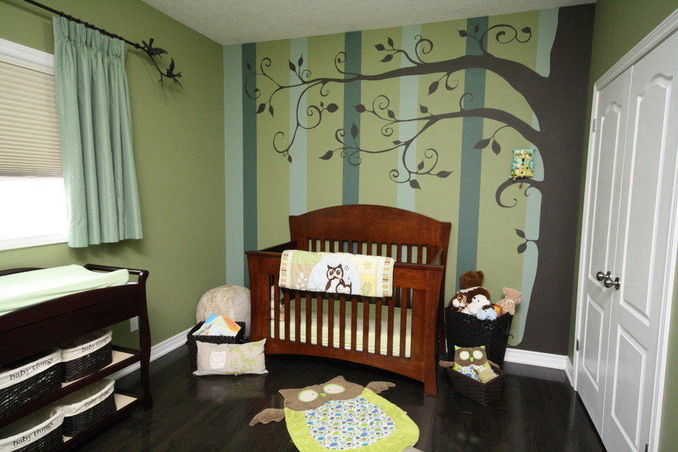Mid-sized transitional gender-neutral dark wood floor nursery photo in Toronto with multicolored walls