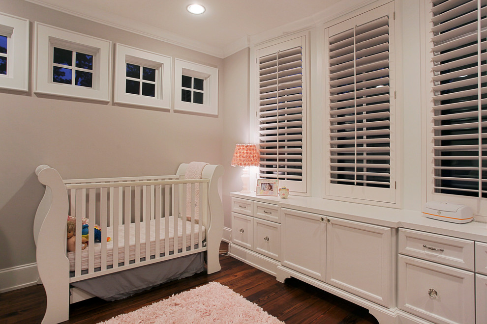Inspiration for a timeless gender-neutral dark wood floor and brown floor nursery remodel in Houston with beige walls