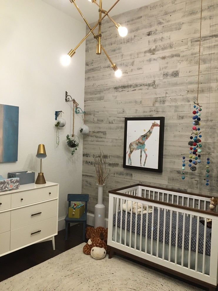 Design ideas for a medium sized eclectic nursery for boys in Miami with white walls and dark hardwood flooring.