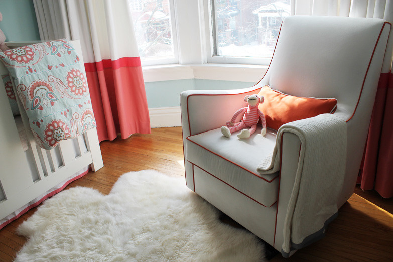 Photo of a medium sized eclectic nursery for girls in Toronto with blue walls and medium hardwood flooring.