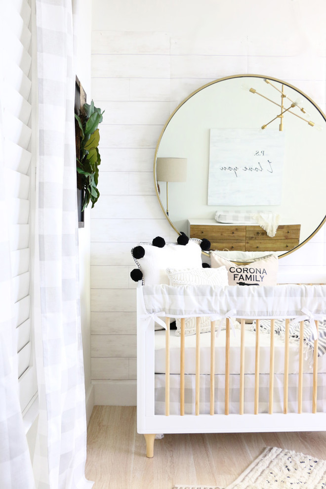 Design ideas for a medium sized rural gender neutral nursery in Other with white walls.