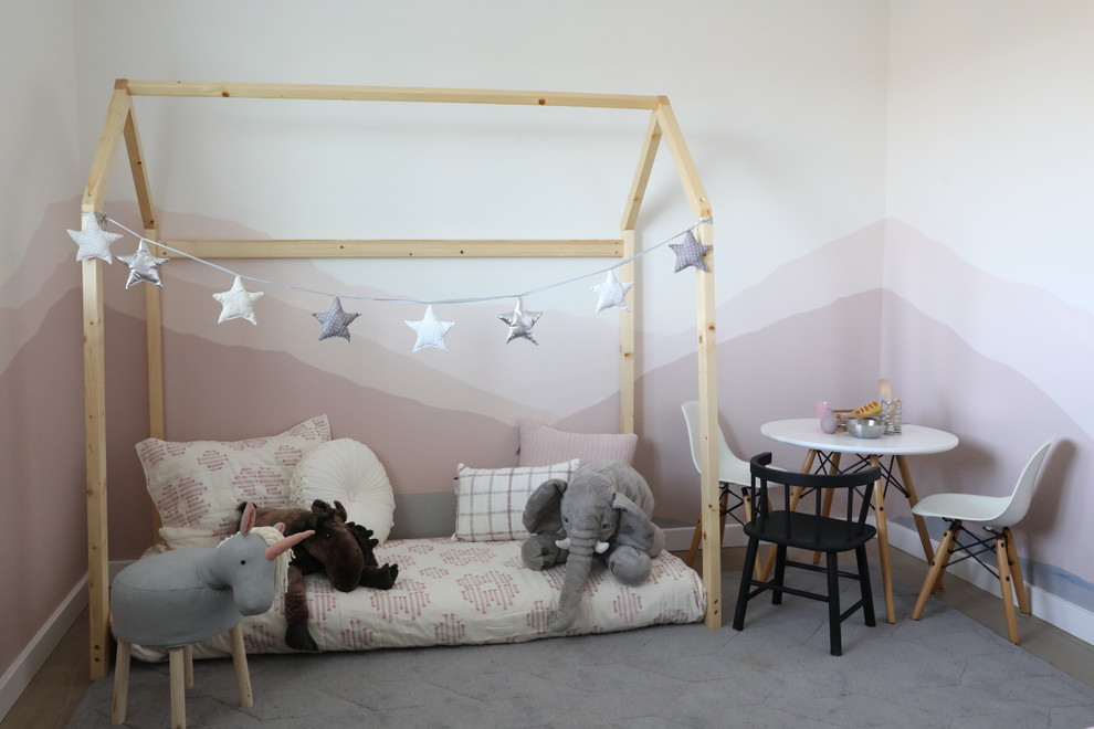 Inspiration for a medium sized modern gender neutral nursery in San Francisco with multi-coloured walls and light hardwood flooring.