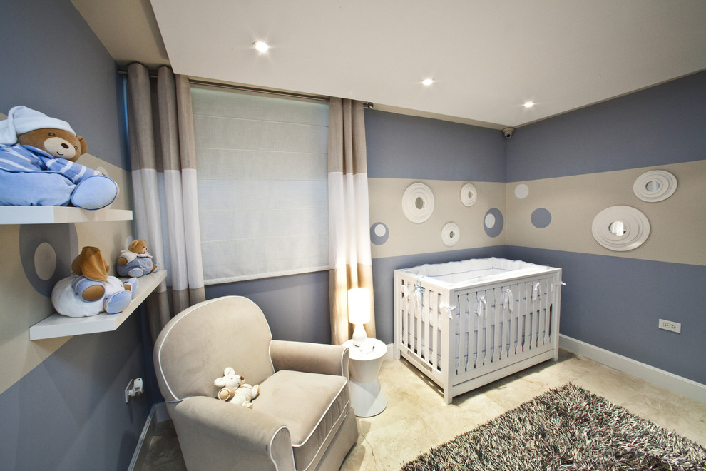 This is an example of a medium sized modern nursery for boys in Other with blue walls.