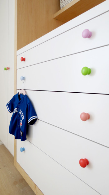 Inspiration for a small contemporary nursery for girls in Toronto with white walls and light hardwood flooring.