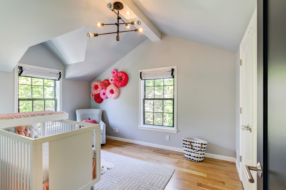 Inspiration for a medium sized traditional nursery for girls in Seattle with grey walls, medium hardwood flooring and brown floors.