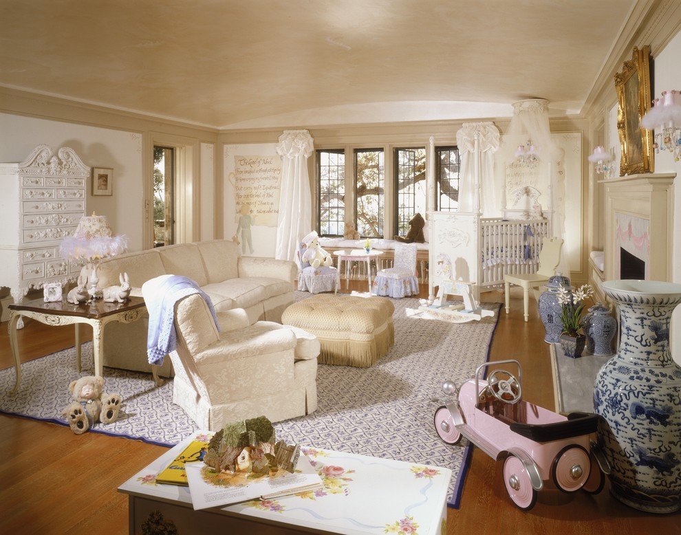 Example of a large classic gender-neutral light wood floor nursery design in Orange County with white walls