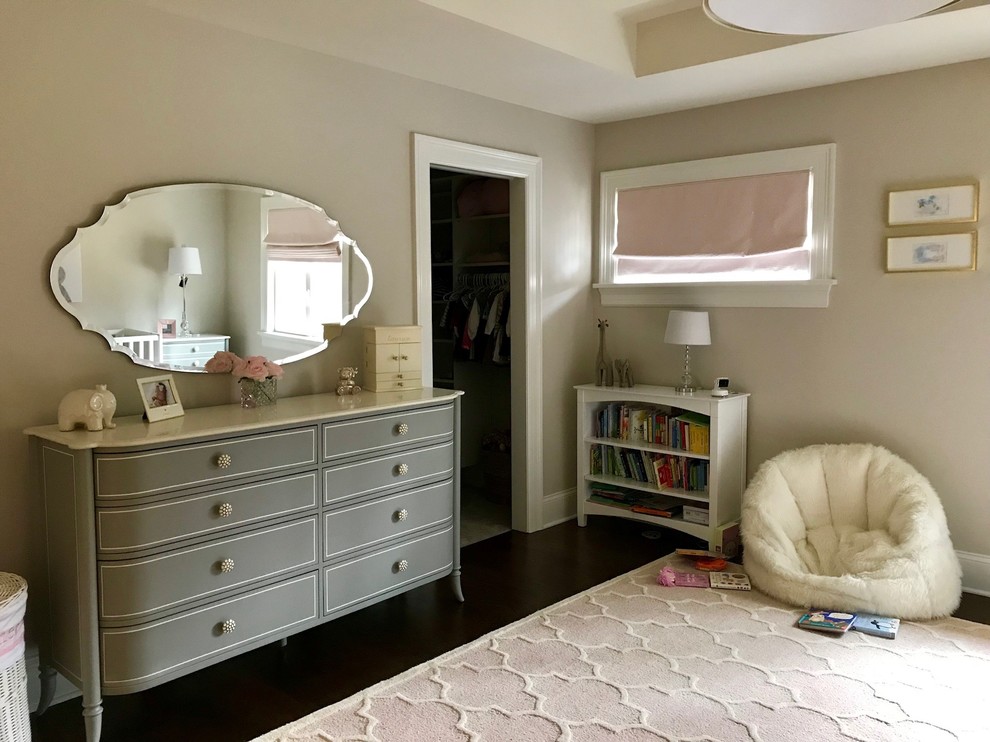 This is an example of a large traditional nursery for girls in Other with beige walls, medium hardwood flooring, brown floors, a coffered ceiling and feature lighting.