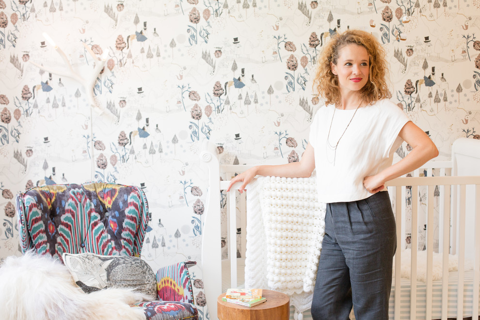 Photo of a small scandi gender neutral nursery in Seattle with white walls, bamboo flooring and beige floors.