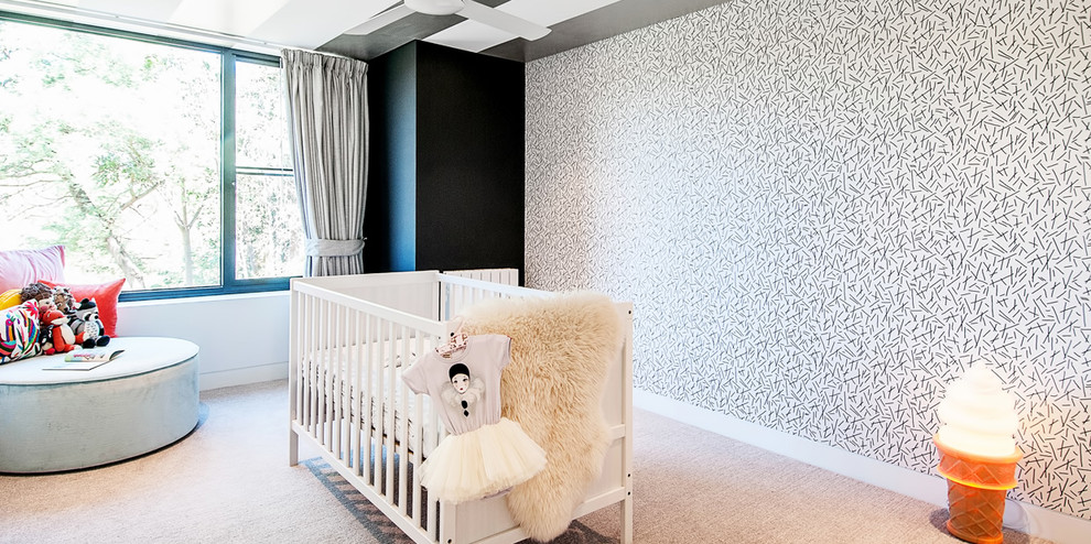 Inredning av ett modernt mellanstort babyrum, med heltäckningsmatta, flerfärgade väggar och grått golv