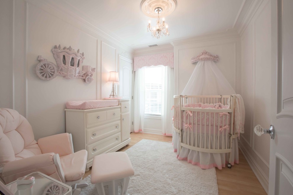 Example of a mid-sized classic laminate floor nursery design in Other with white walls