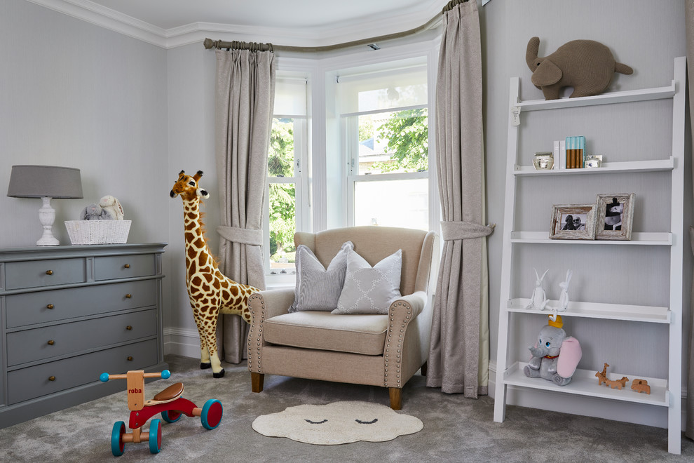 This is an example of a classic gender neutral nursery in London with grey walls, carpet and grey floors.