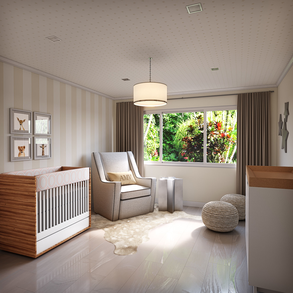 Ejemplo de habitación de bebé niña contemporánea con paredes beige y suelo de madera clara