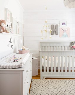 nursery prints in a gallery wall set in a pale nursery
