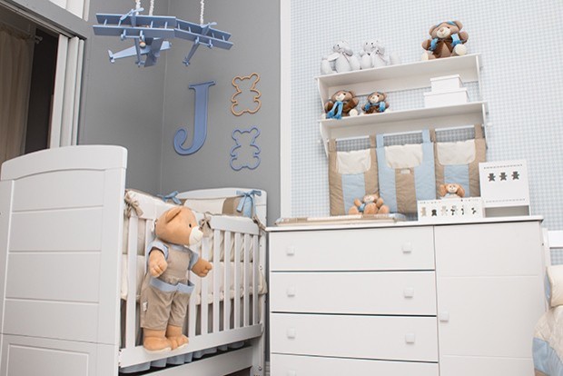 Photo of a modern nursery for boys in Other with grey walls, carpet and beige floors.