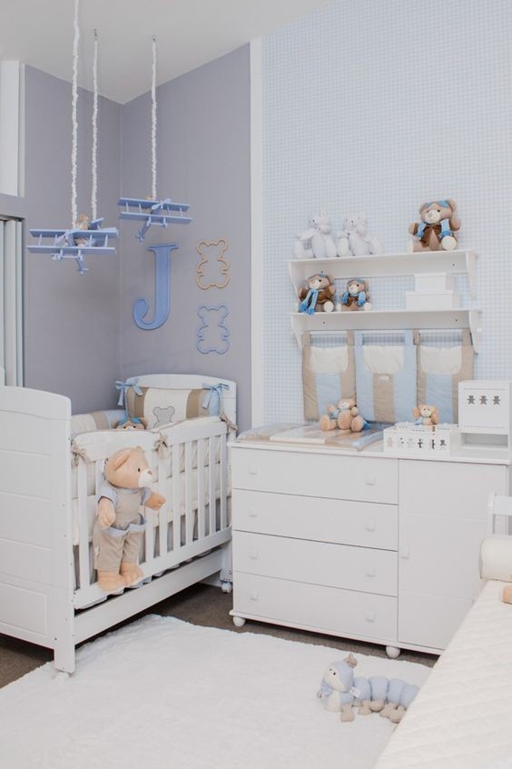 This is an example of an expansive modern nursery for boys in Other with carpet, beige floors and grey walls.