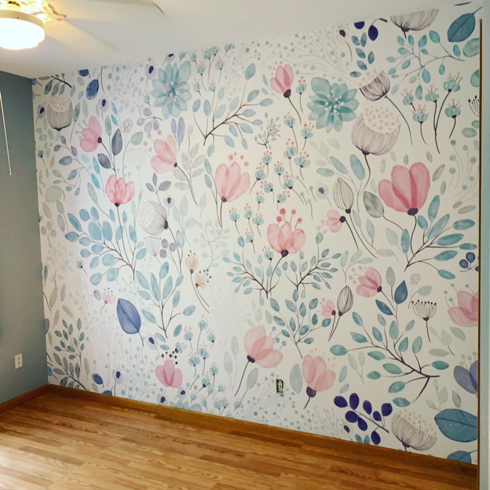Photo of a medium sized traditional nursery for girls in Minneapolis with multi-coloured walls, medium hardwood flooring and brown floors.
