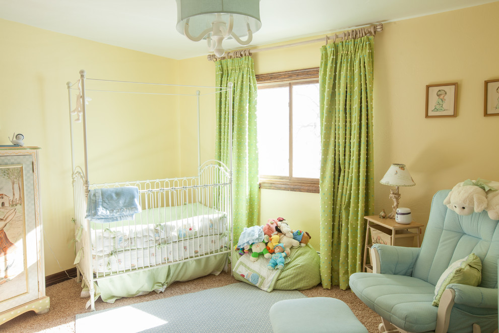 Small traditional gender neutral nursery in Omaha with yellow walls, carpet and beige floors.