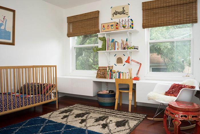 Medium sized bohemian nursery for girls in Austin with white walls, dark hardwood flooring and brown floors.