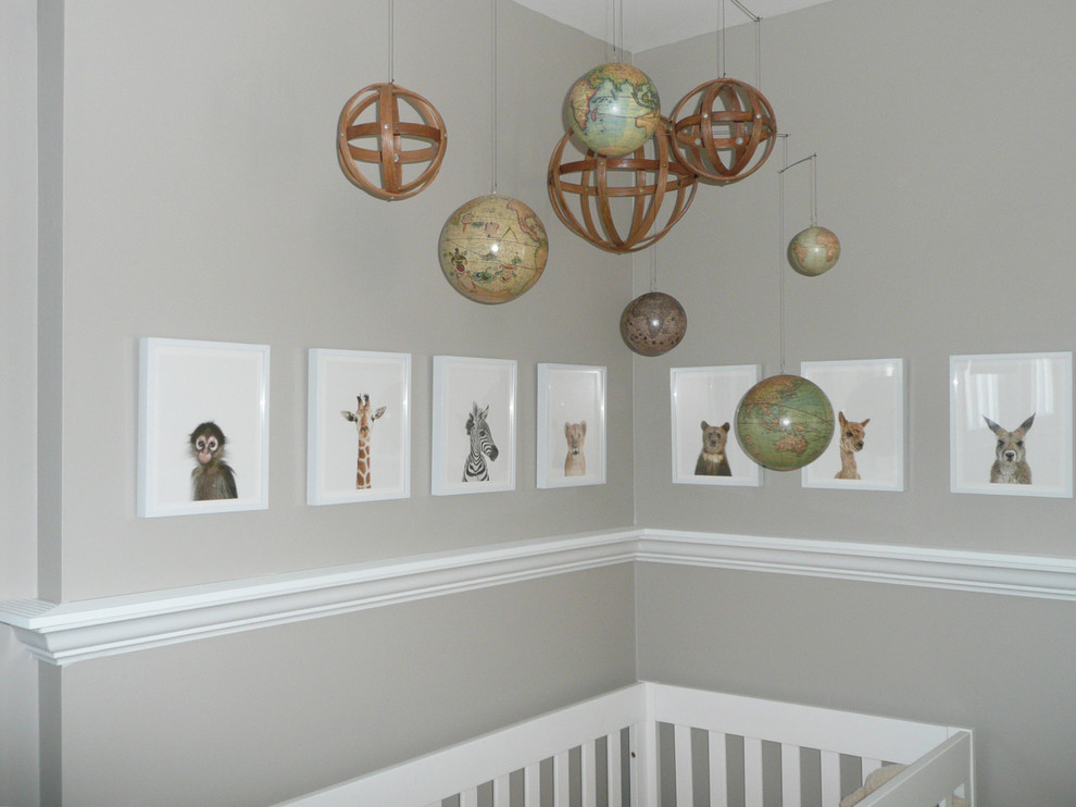 This is an example of a medium sized bohemian gender neutral nursery in Other with grey walls.