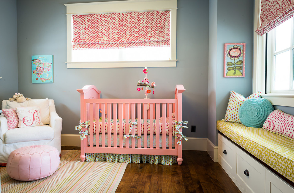 Inspiration for a mid-sized transitional girl medium tone wood floor nursery remodel in Denver with gray walls