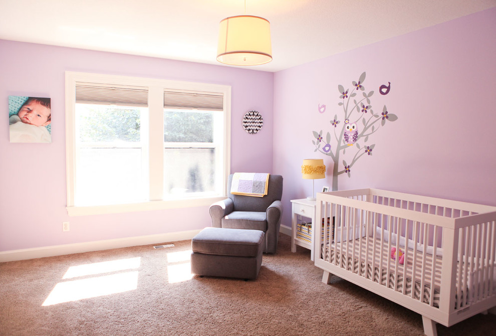 Large classic nursery for girls in Portland with purple walls and carpet.