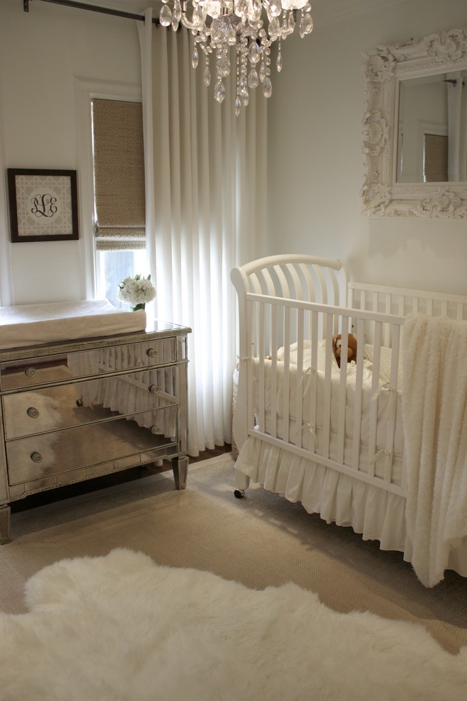 This is an example of a traditional nursery for girls in Dallas with white walls and feature lighting.