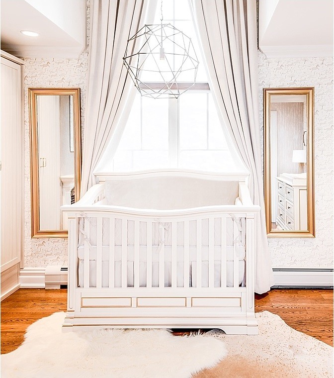 This is an example of a classic nursery for boys in New York with multi-coloured walls, medium hardwood flooring and brown floors.