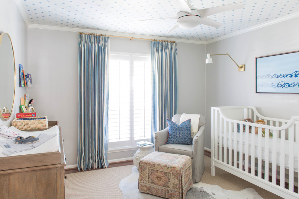 This is an example of a medium sized beach style nursery for boys in Houston with grey walls and dark hardwood flooring.