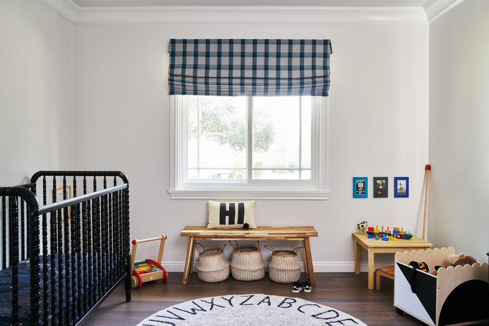 Design ideas for a small traditional gender neutral nursery in Charlotte with white walls, dark hardwood flooring and brown floors.