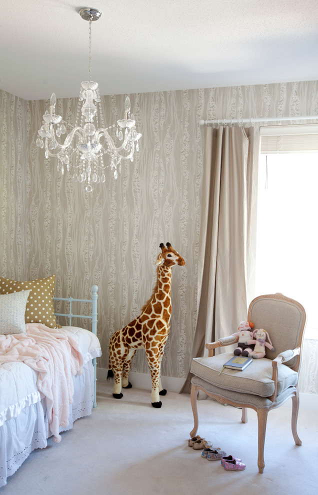 Photo of an eclectic nursery for girls in Vancouver with beige walls and carpet.