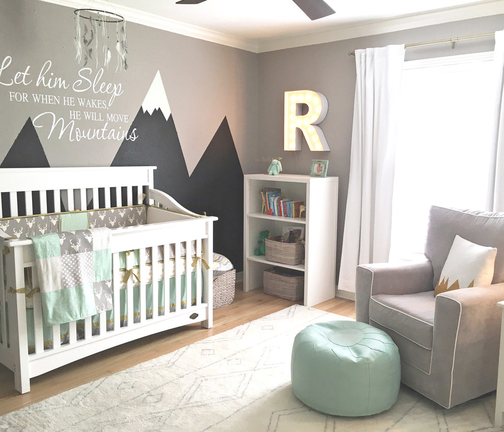 Design ideas for a large classic nursery for boys in Austin with grey walls and light hardwood flooring.