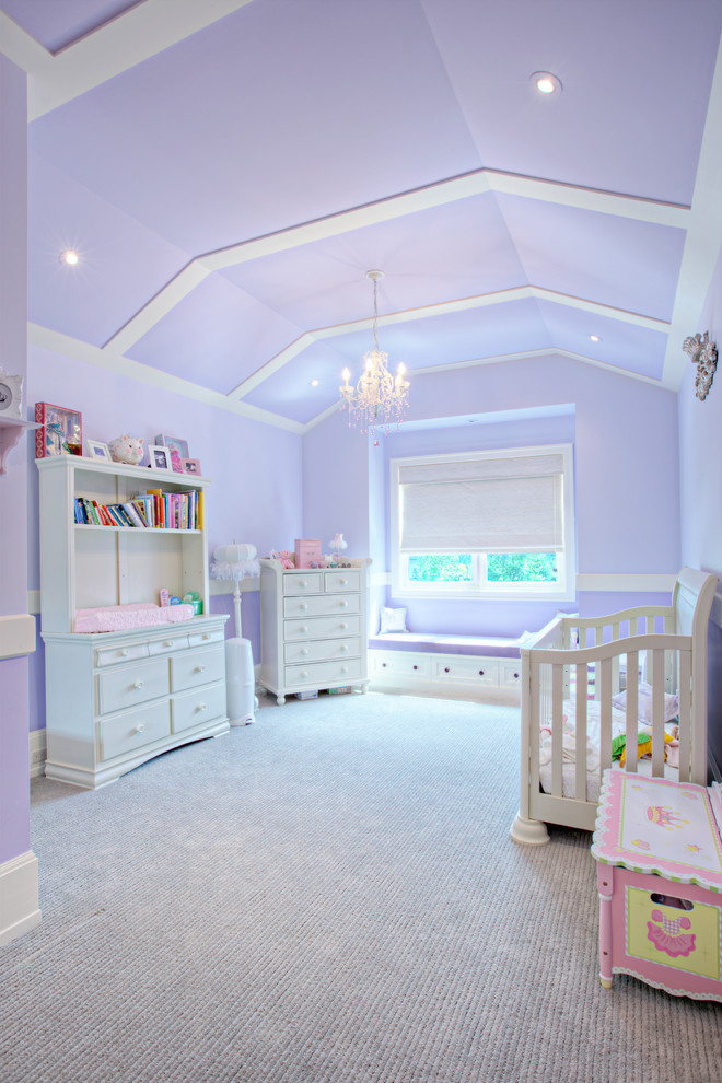 Medium sized traditional nursery for girls in Calgary with purple walls, carpet and grey floors.